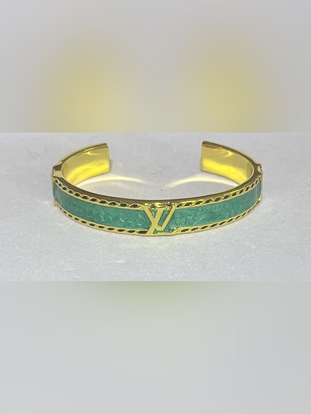 Gold-Tone Cuff Bracelet with Green Enamel and Signature Accent
